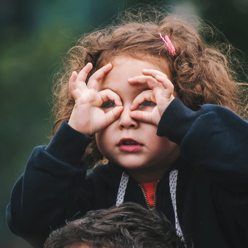 Child Making Glasses Out of Her Hands - Photo by Edi Libedinsky on Unsplash.com